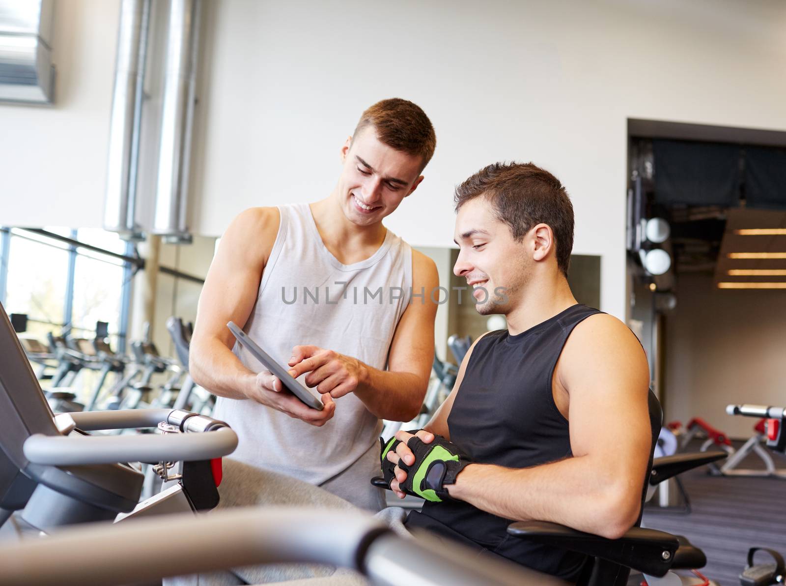 men exercising on gym machine by dolgachov