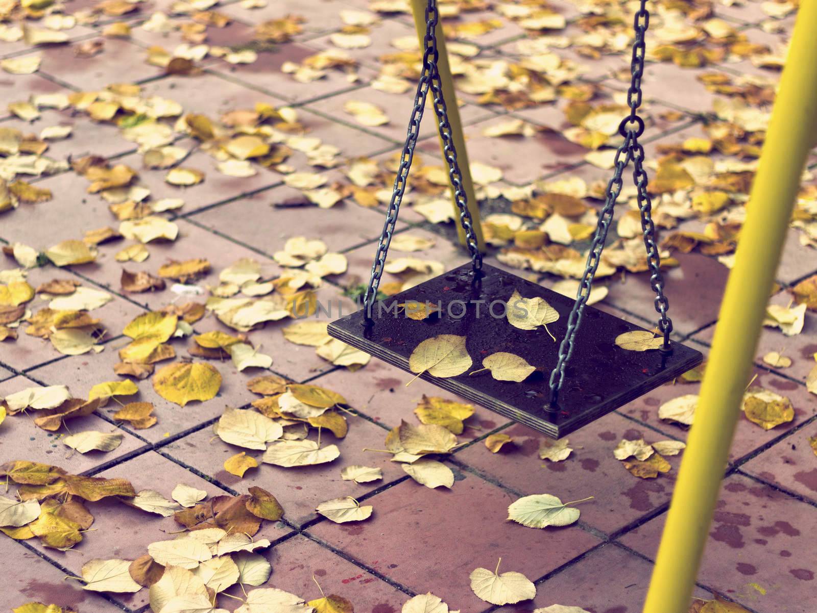 Empty chain swing in playground   by Kidza