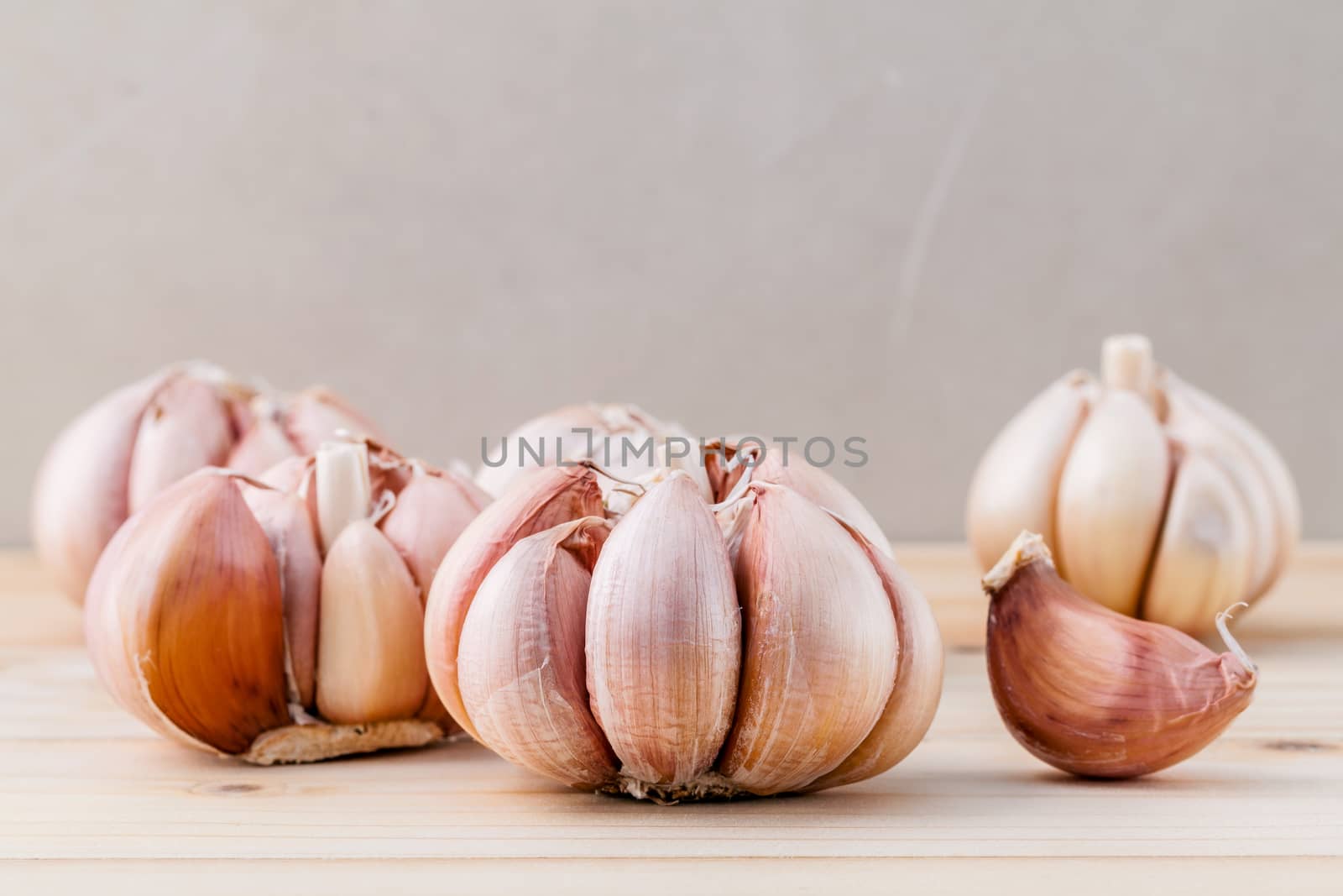 Close Up organic garlic with selective focus on the teak wood background