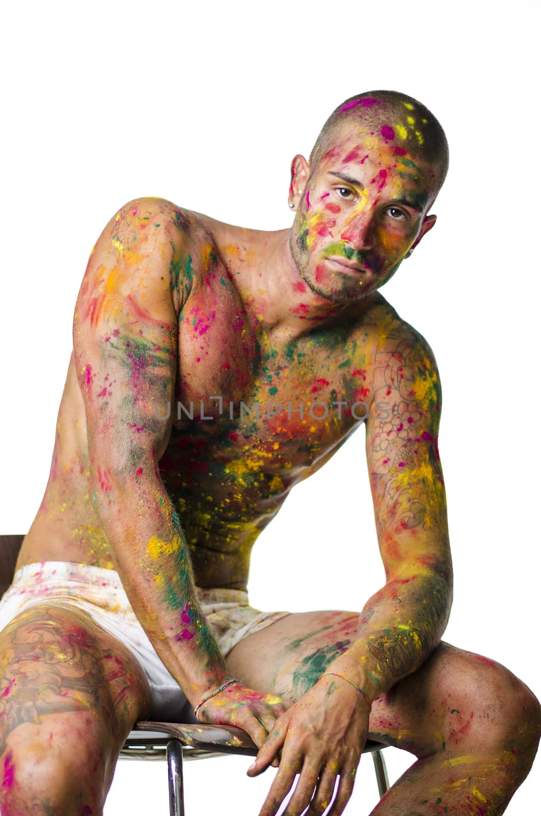 Handsome young man with skin all painted with Holi colors by artofphoto