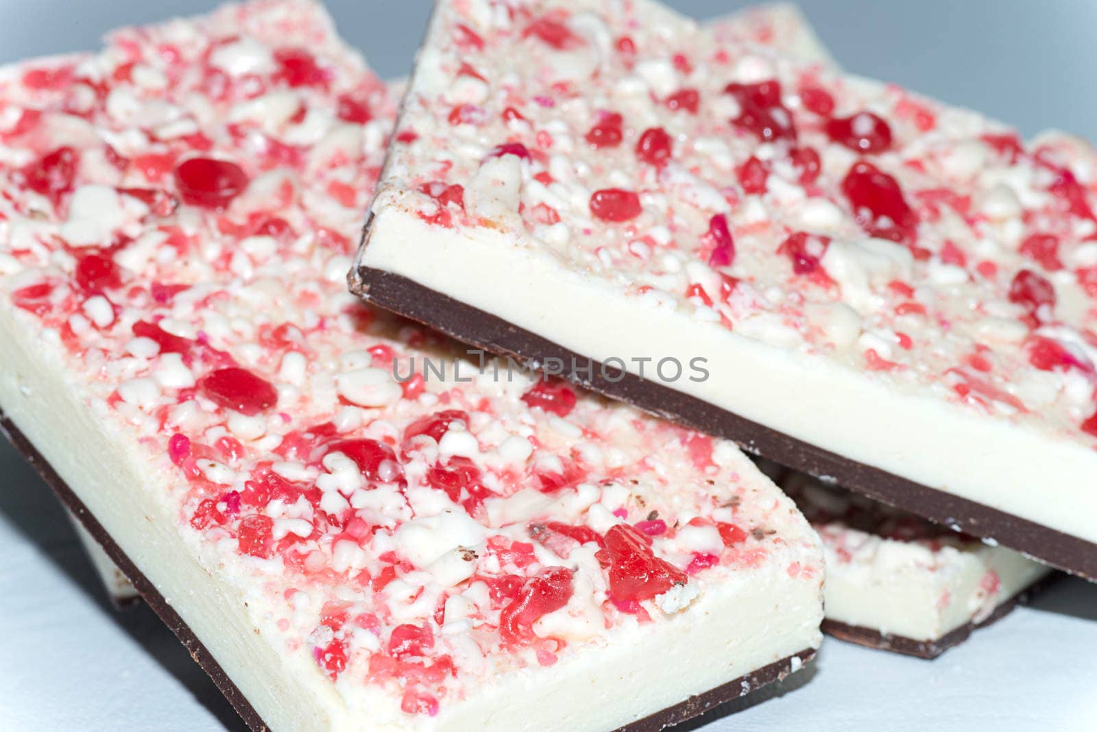 Close-up of candy cane topped white and dark chocolate bark.