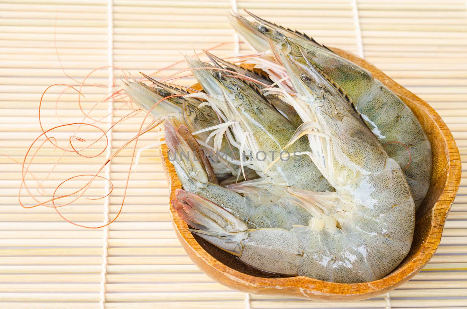 Fresh Gulf Shrimps in cup on wood background.