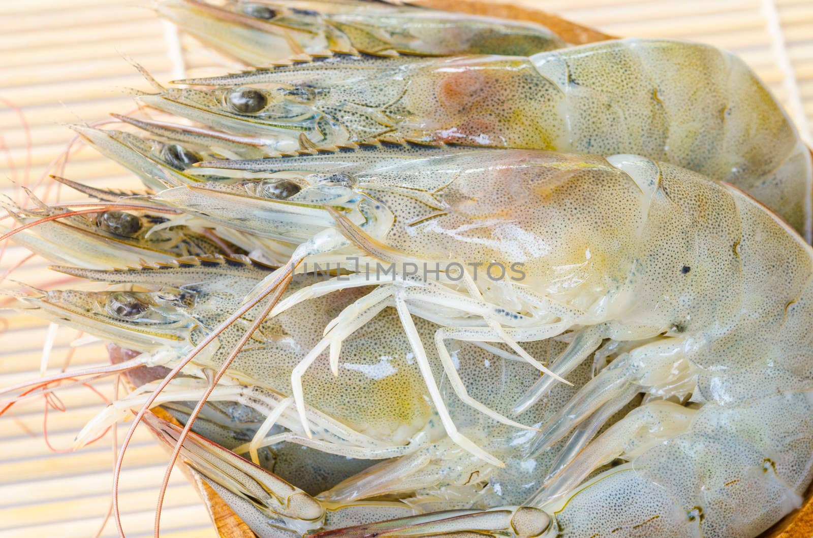 Top view of Fresh Gulf Shrimps in cup on wooden background.