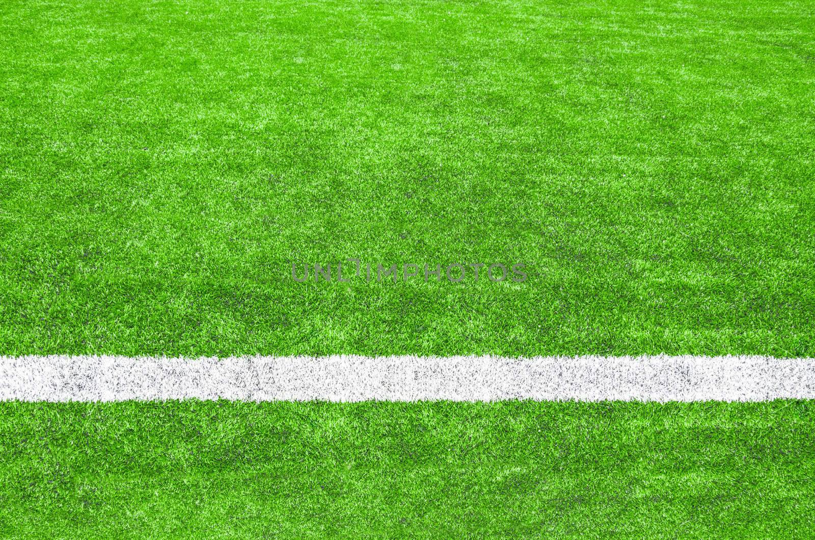 White stripe on the green soccer field.