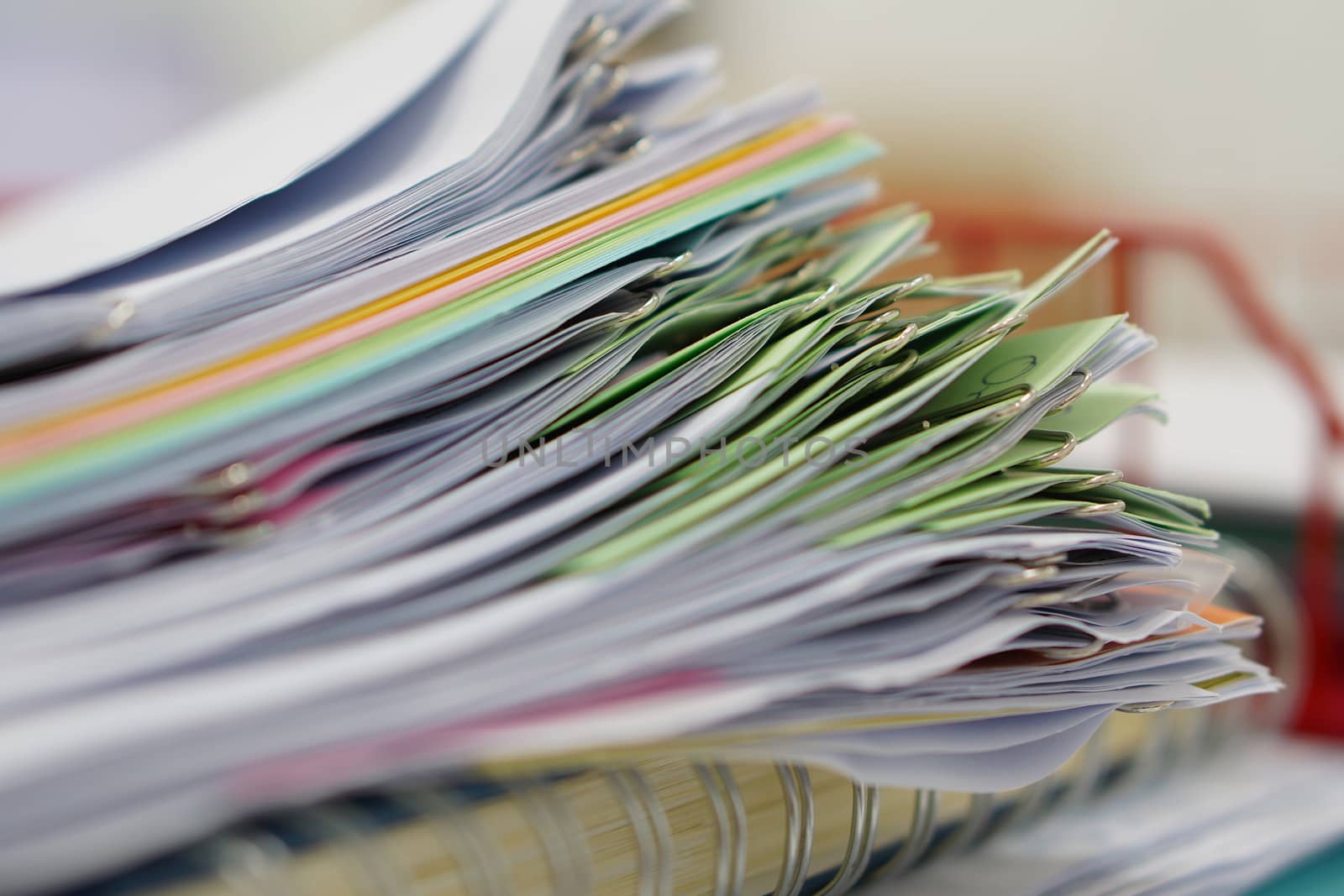 Pile of documents and blur notebook in basket at office.