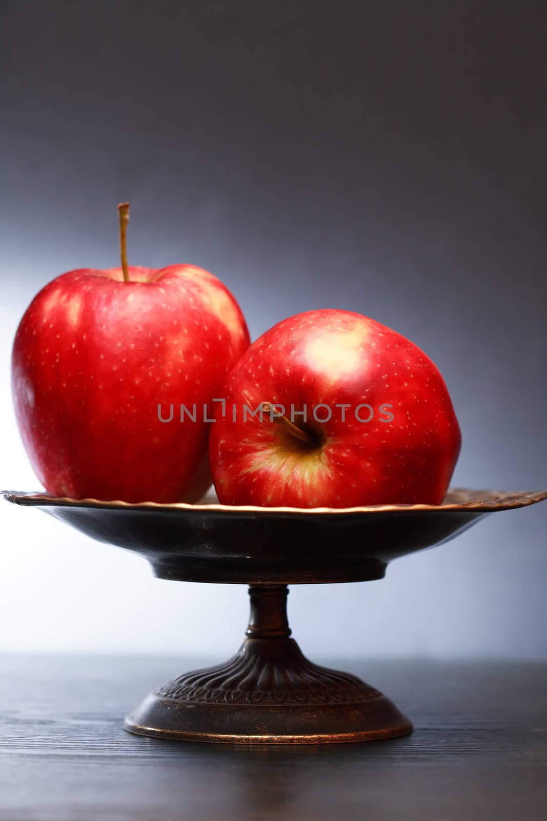 Two red apples in nice metal vintage fruit bowl