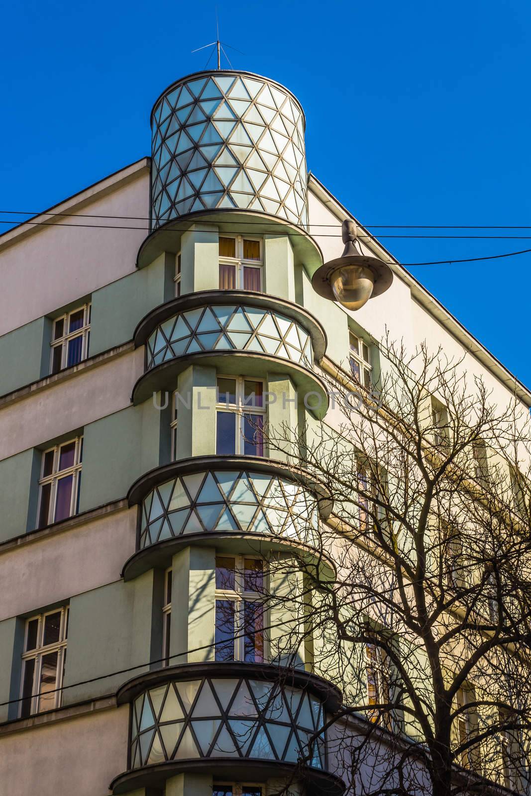 Tenement being an interesting example of modernism architectural style in Gliwice on February 08, 2014. Characteristic rounded corner is filled with milk glass, which is illuminated at night.