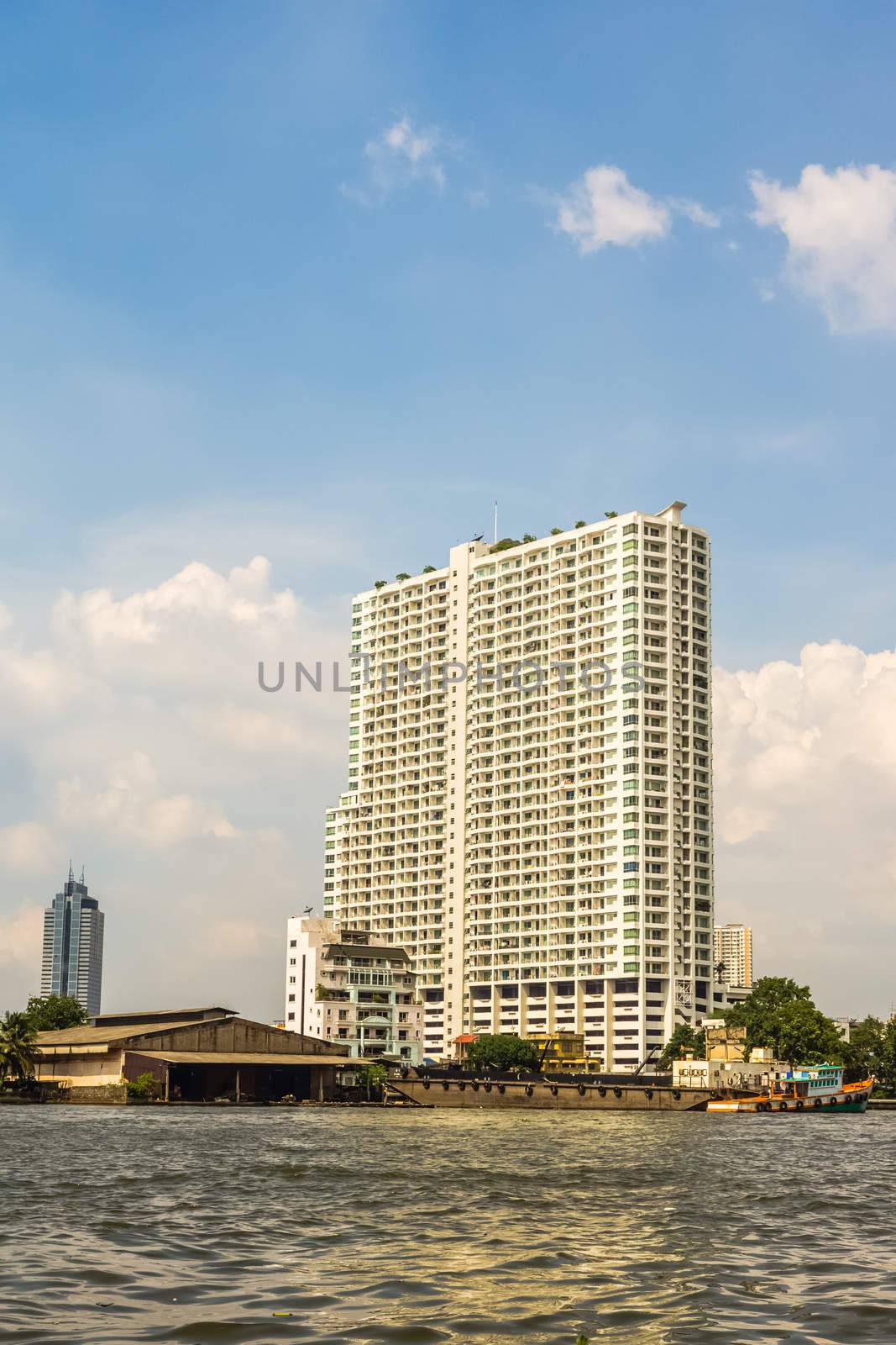 Supalai River Place condominium. A modern 34 storey residential building on the curve of the Chaophraya River with roof garden, pool, sauna and sport facilities.