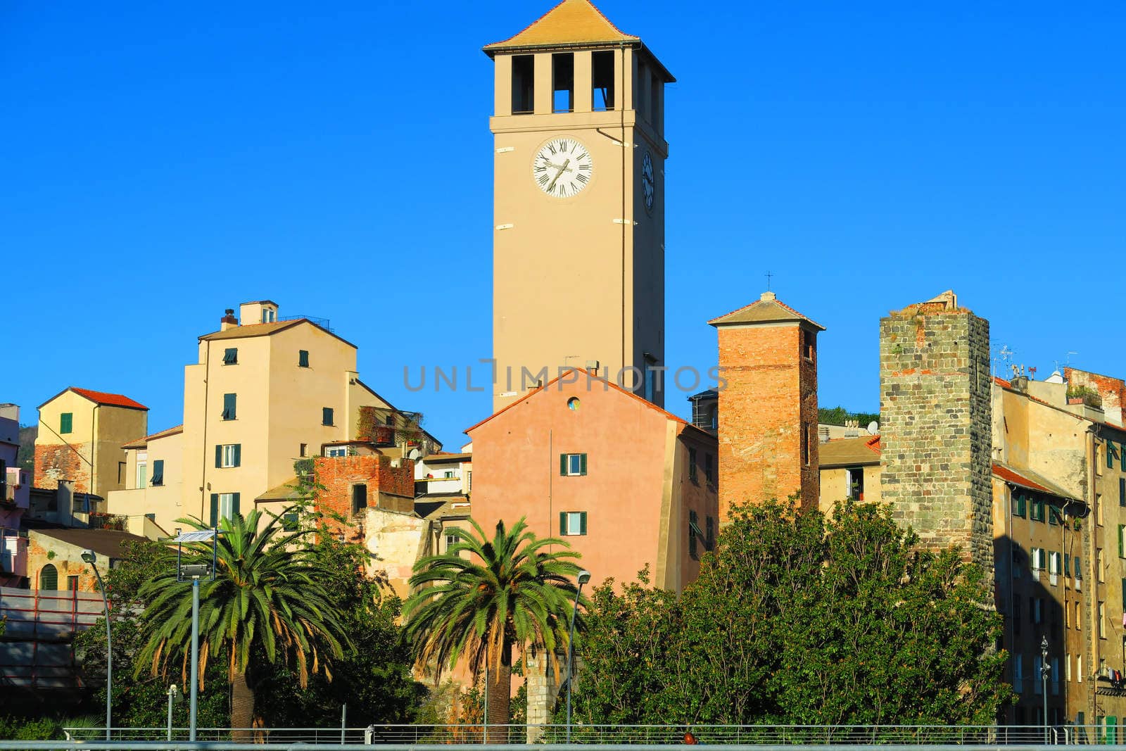 Glimpse of Savona, Italy, is visible in the center of the shot, the tower Brandale (XII century) flanked by other towers.