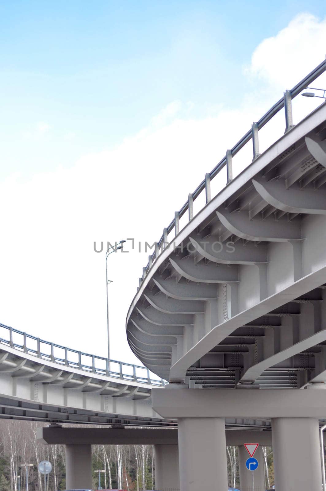 automobile overpass on background of blue sky with clouds. bottom view