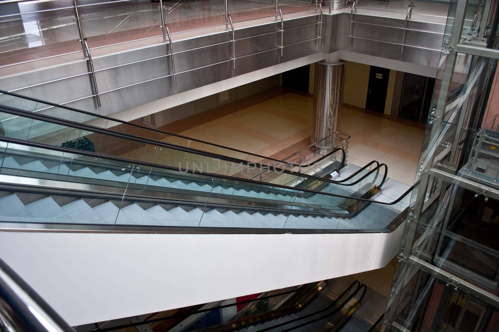 glass elevator shafts, escalators  in a modern office building