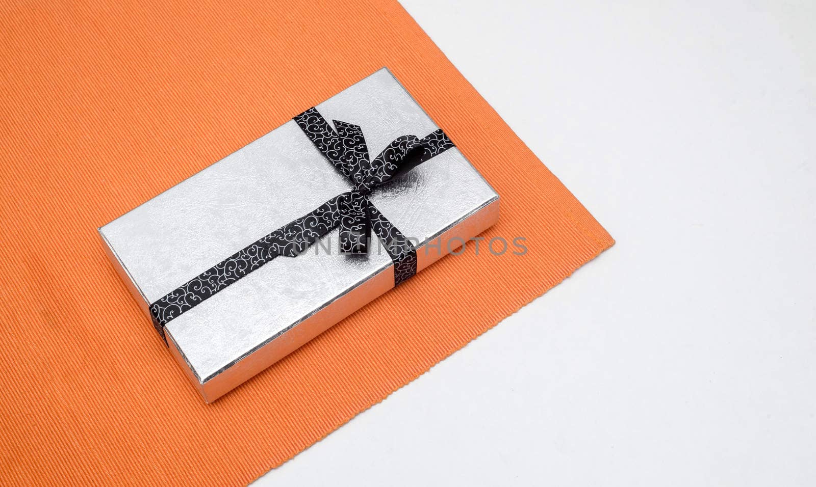 silver gift box with bow on white background