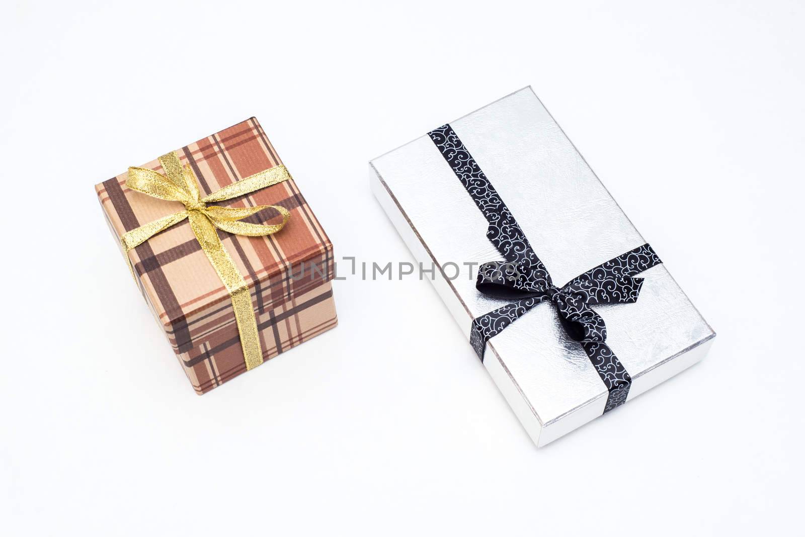 brown and silver gift box with bow on white background