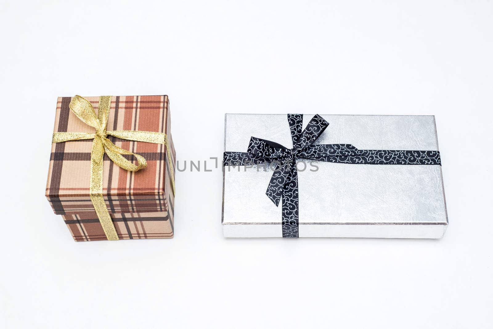 brown and silver gift box with bow on white background
