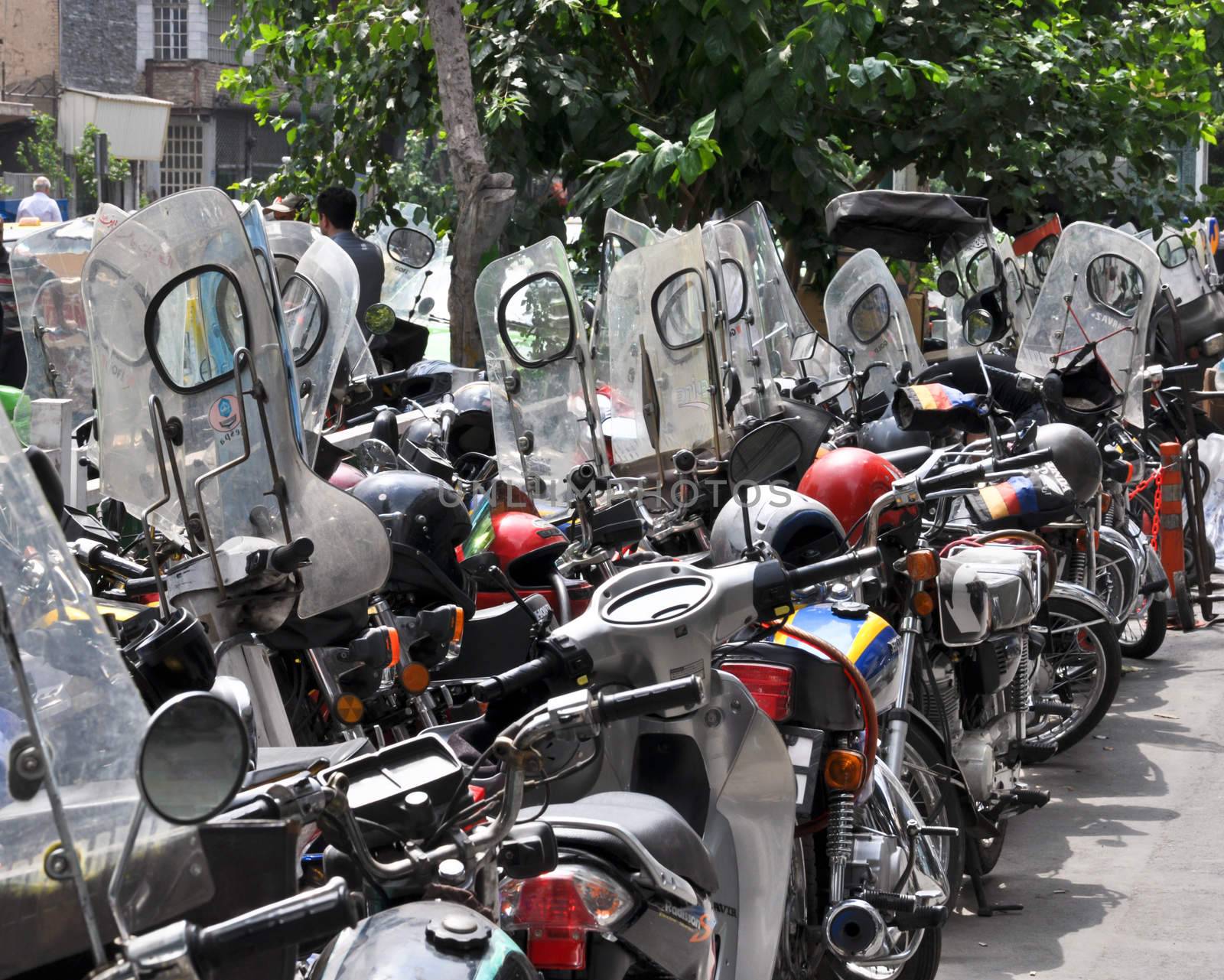 a lot of mopeds parked Tehran, Iran by vlaru