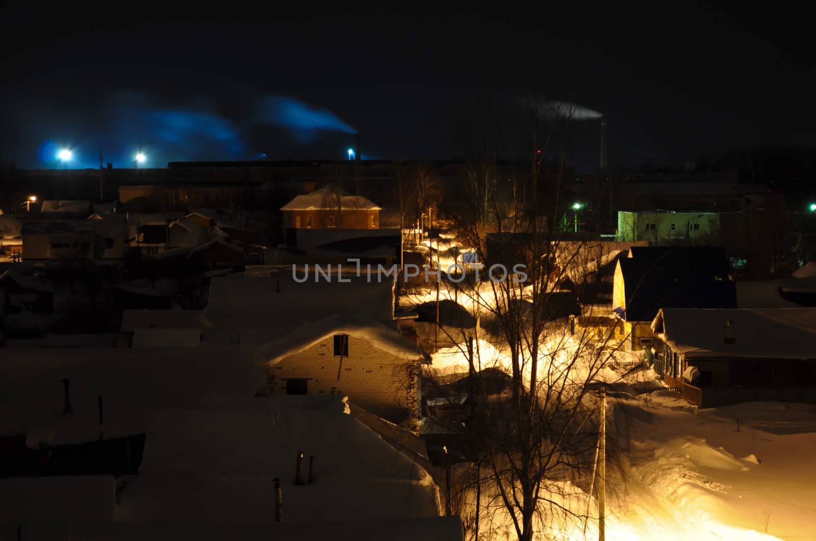 Night Village with smoking chimneys on the horizon