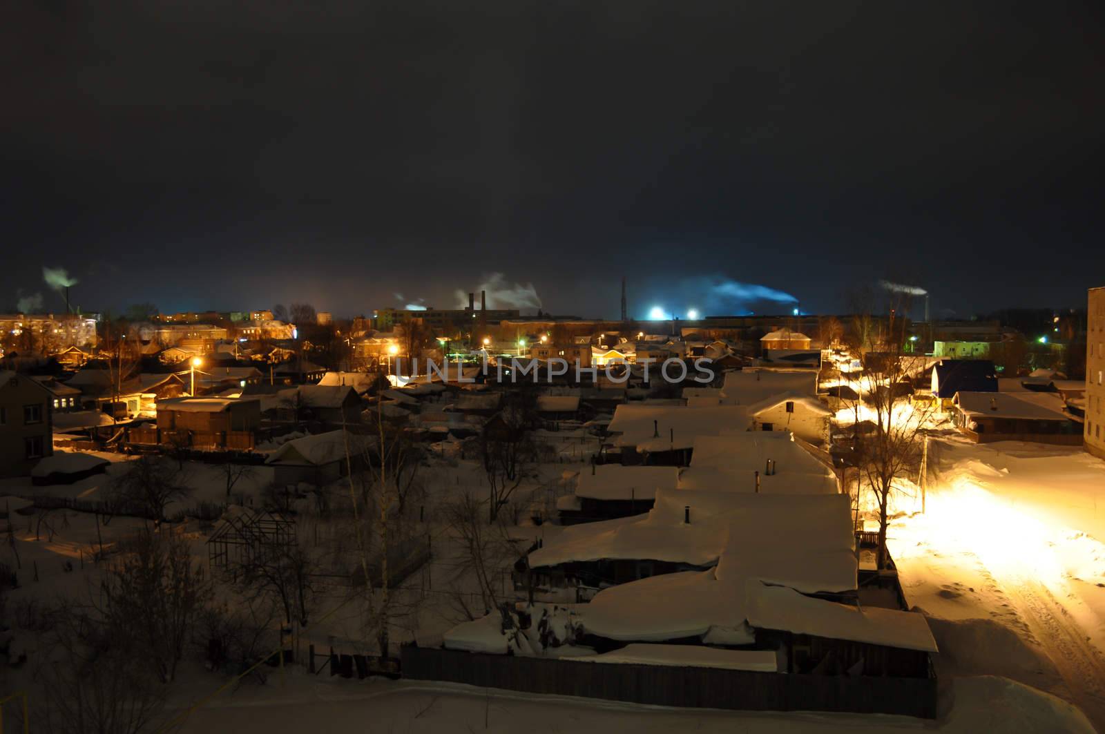 Night Village with smoking chimneys on the horizon