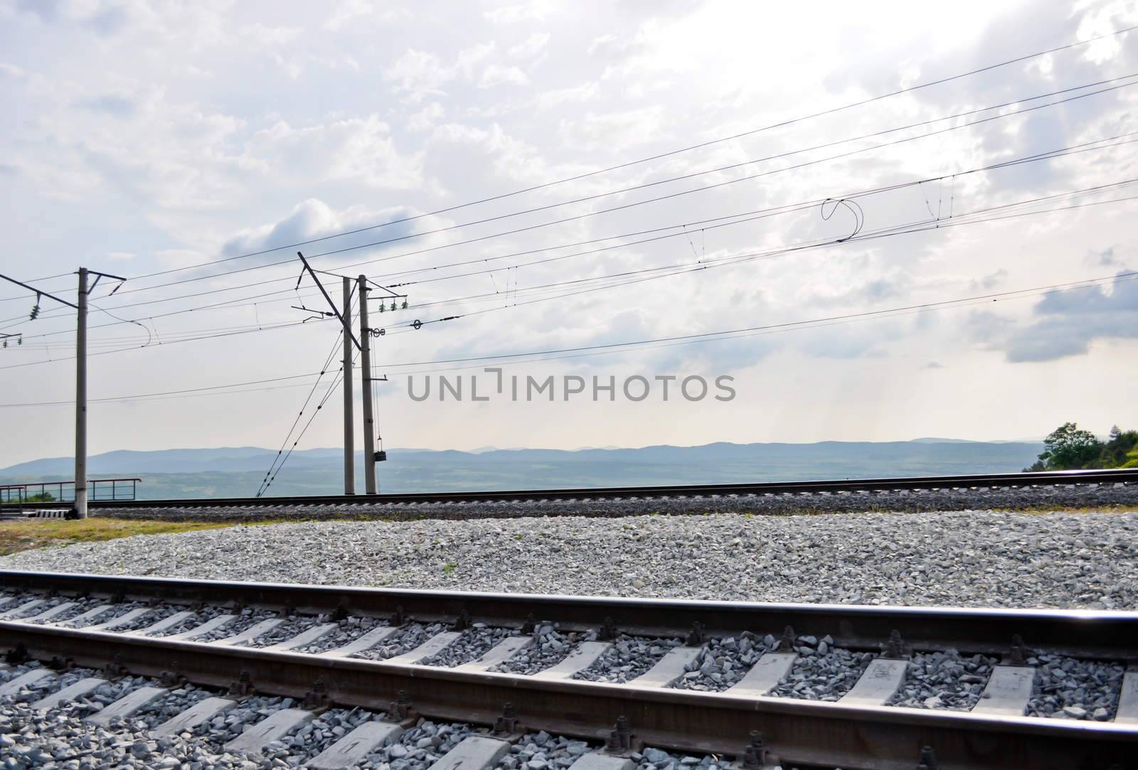 railroad track, embankment, and power poles by vlaru