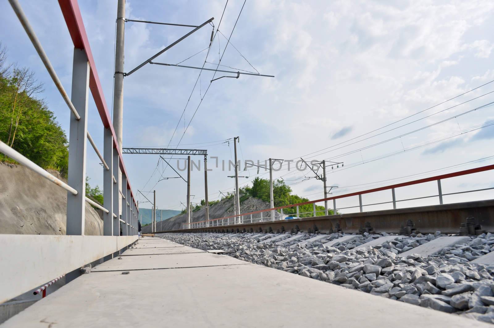 railroad track, embankment, and power poles