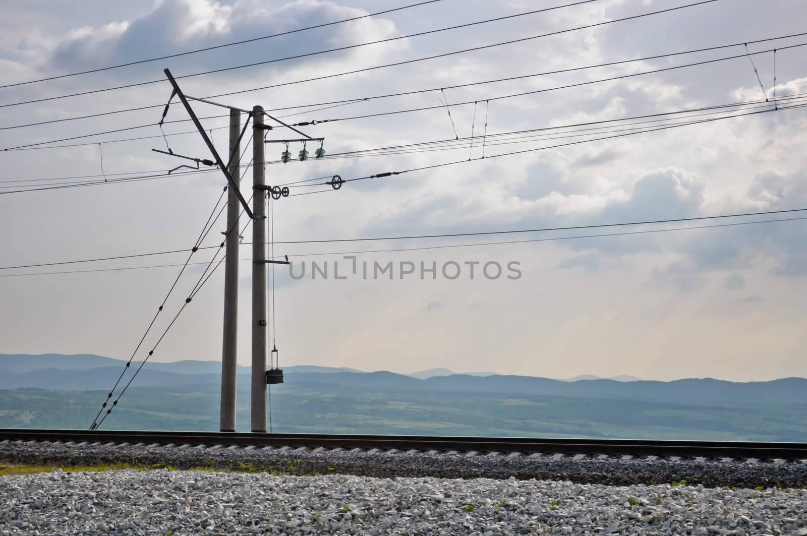 railroad track, embankment, and power poles by vlaru