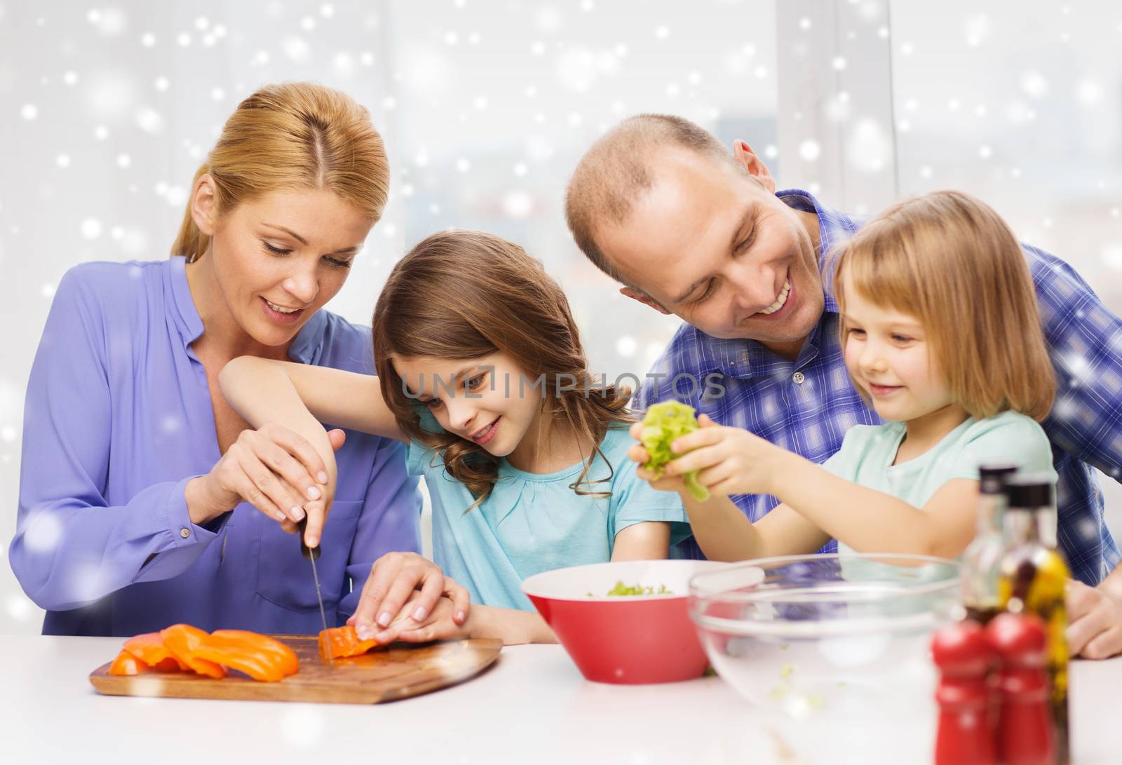 happy family with two kids making dinner at home by dolgachov