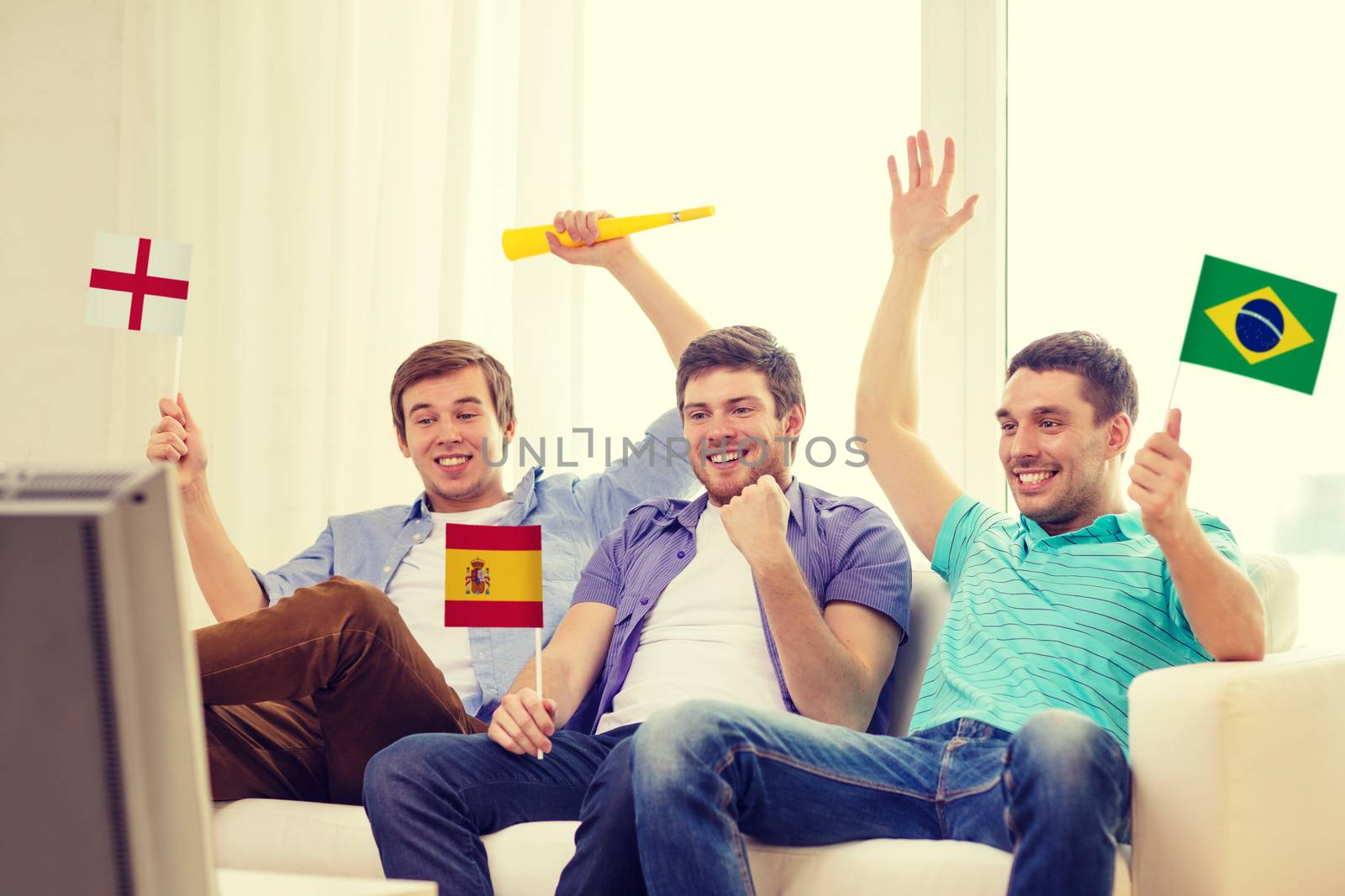 happy male friends with flags and vuvuzela by dolgachov