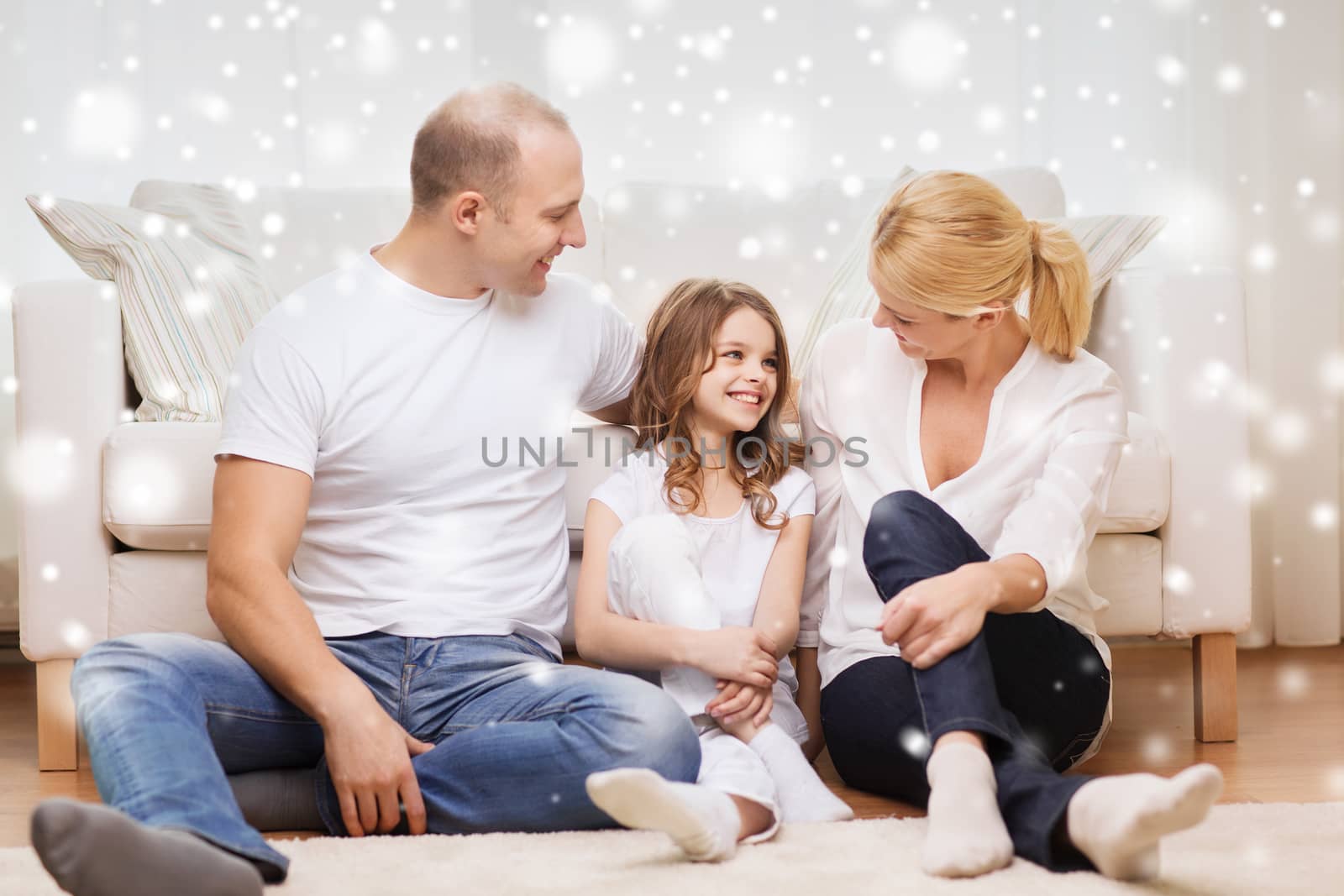 smiling parents and little girl at home by dolgachov