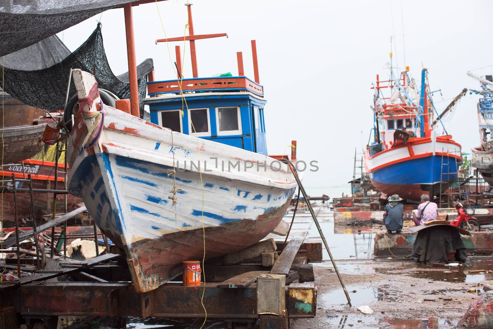 Naklua, Pattaya City, Thailand - June 26, 2015: Thailand is famous for its food, and a vast fleet of fishing vessels take to sea every day to catch fresh fish. Here’s a shipyard in Naklua, Pattaya, that maintains the boats.