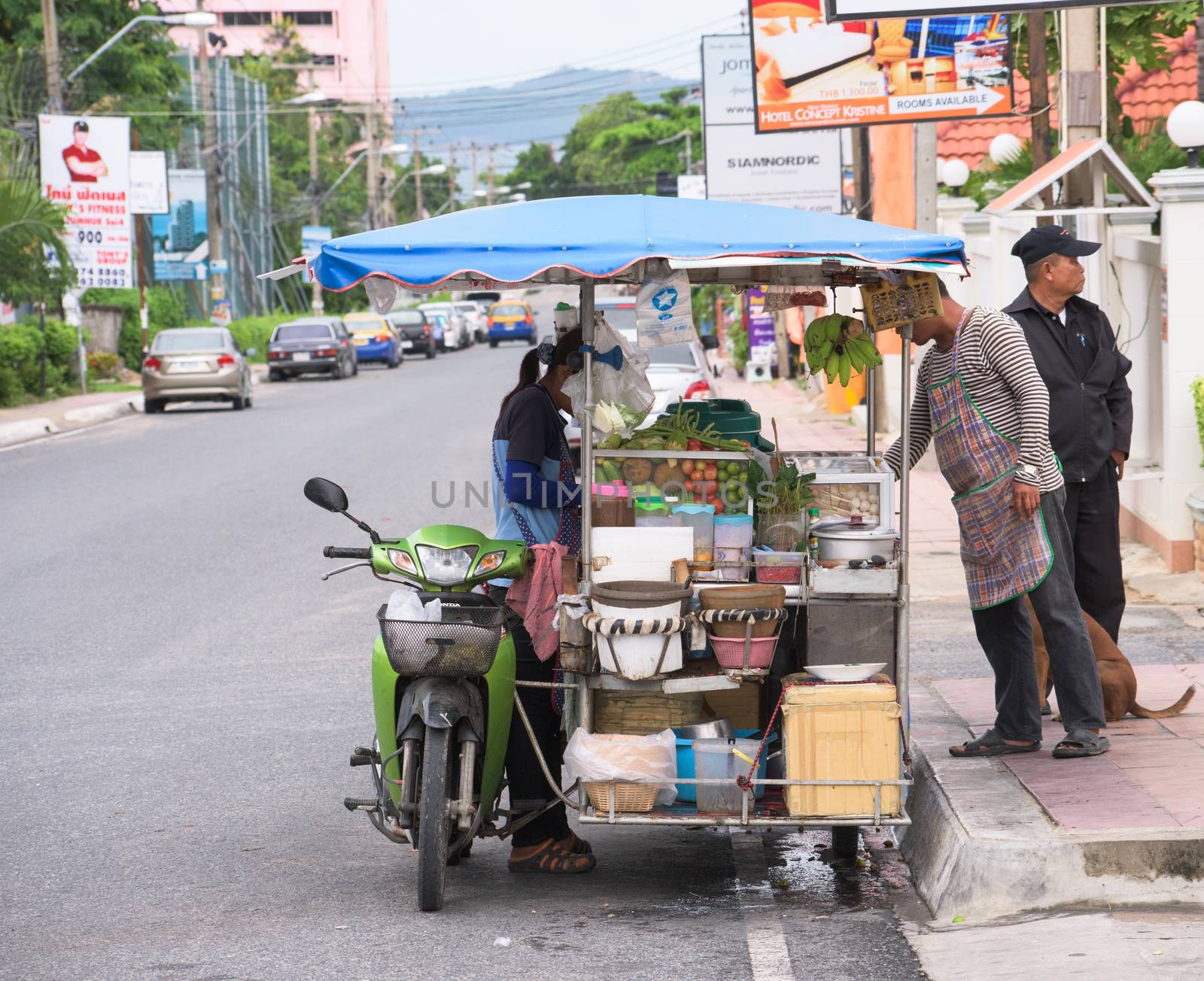 Pattaya City, Thailand - June 26, 2015: Thailand is famous for its street food, which is tasty and can be bought everywhere around the clock. Here’s a mobile kitchen selling meatballs and the spicy papaya salad, som tam.