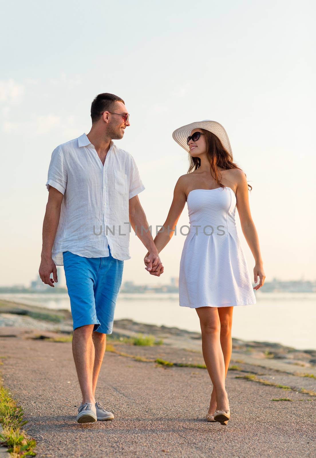 smiling couple walking outdoors by dolgachov