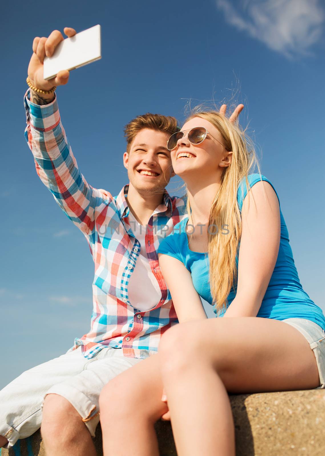 holidays, vacation, love and friendship concept - smiling couple having fun outdoors