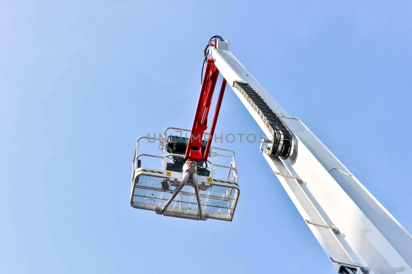 white hydraulic construction cradle against the blue sky