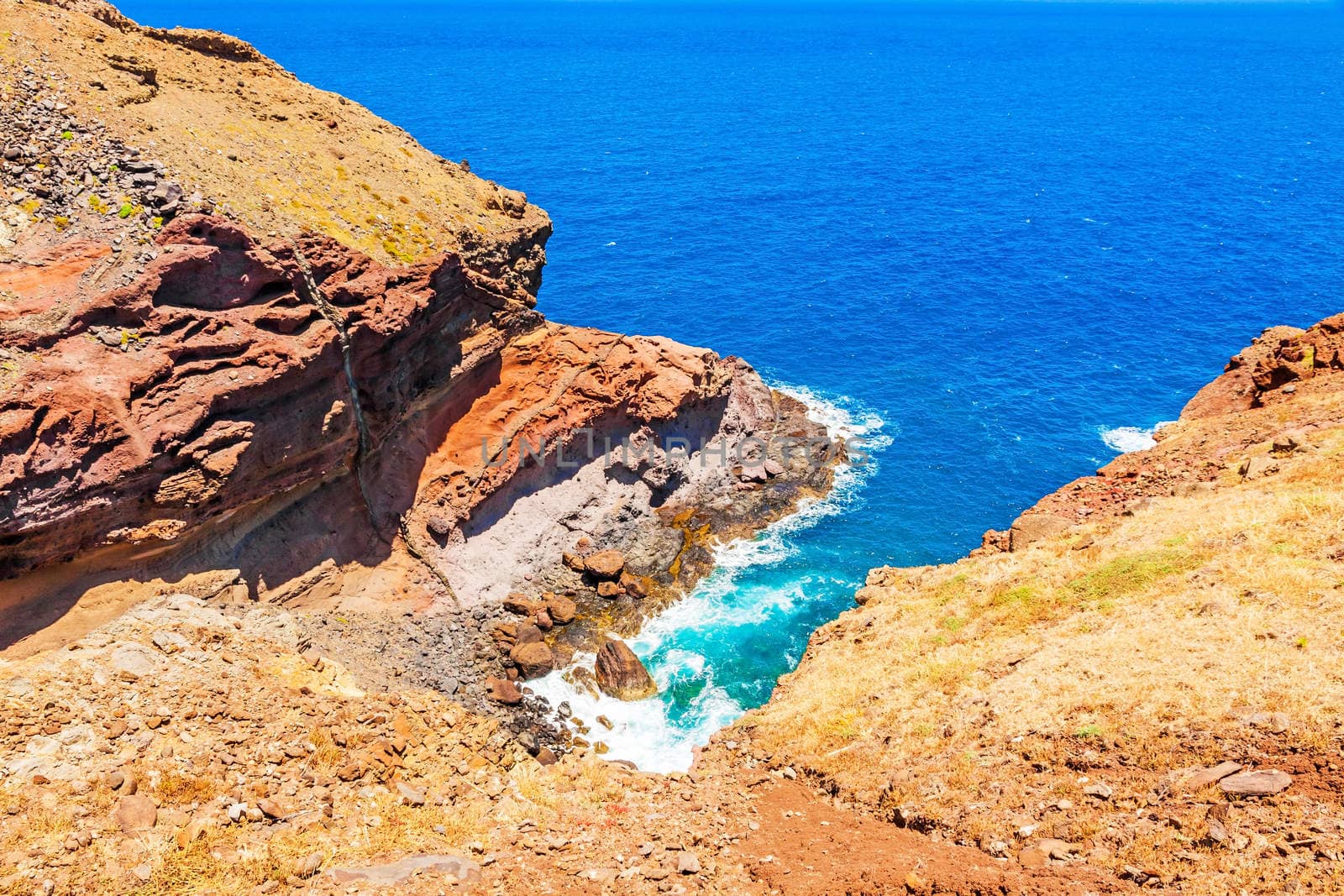 Madeira - colorful cliff coast, rocks at bay with surge of waves of the Atlantic Ocean