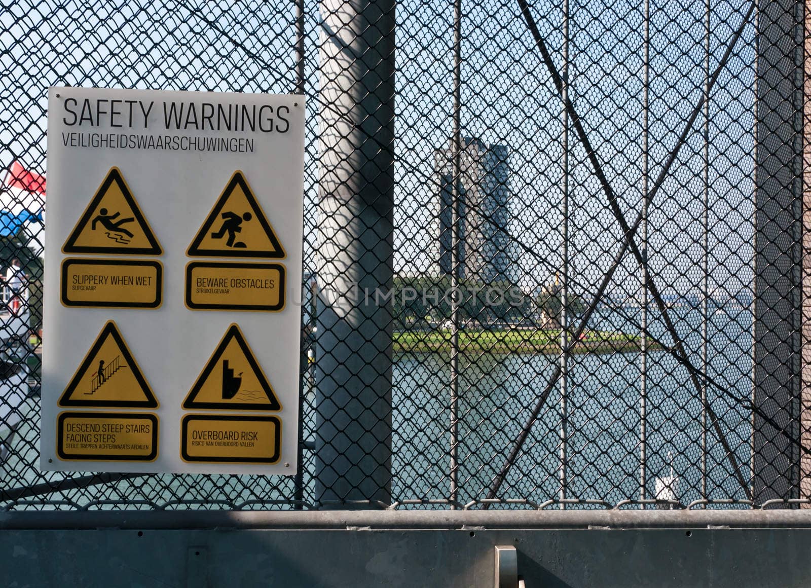 Danger warning signs hanging on a metal grid