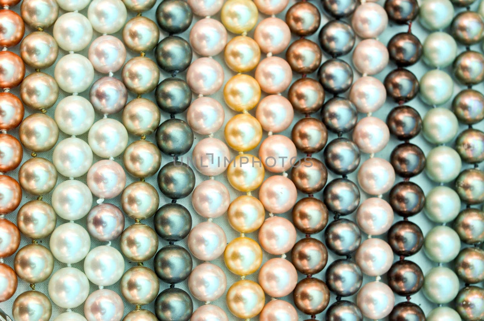 a lot of pearl beads close up by vlaru