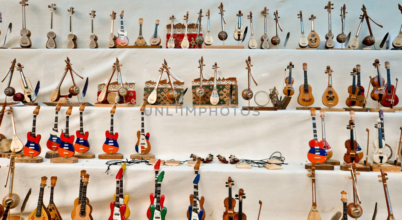 People craft miniature musical instruments made of wood by vlaru