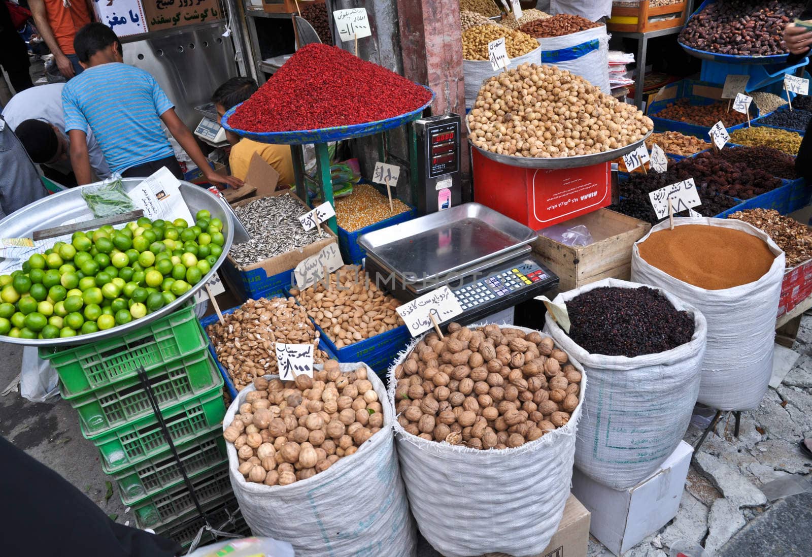 spices and nuts on the scales and dishes in an old bazaar in Tehran, Iran by vlaru