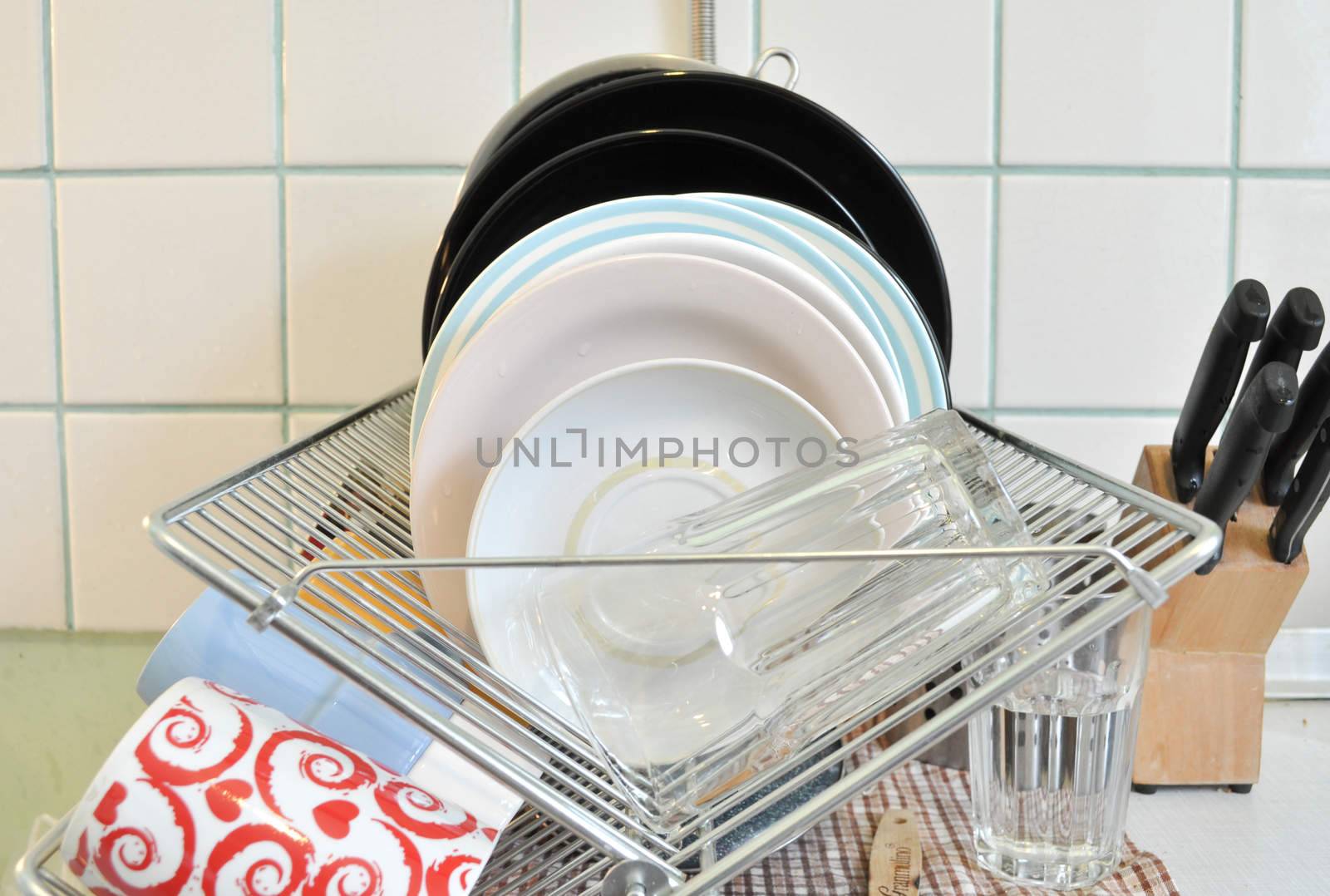 the clean dishes on the rack by vlaru