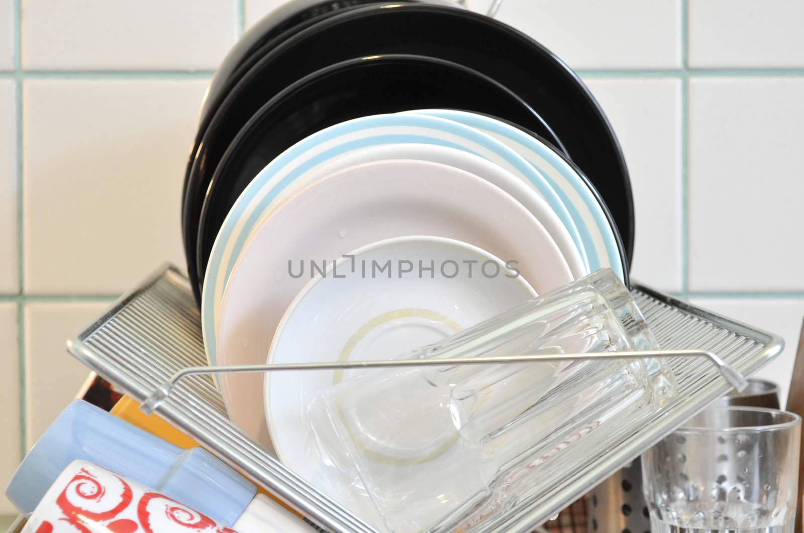 the clean dishes on the rack by vlaru