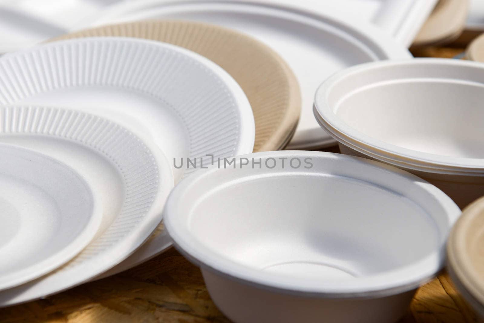 a variety of paper disposable plates of different colors