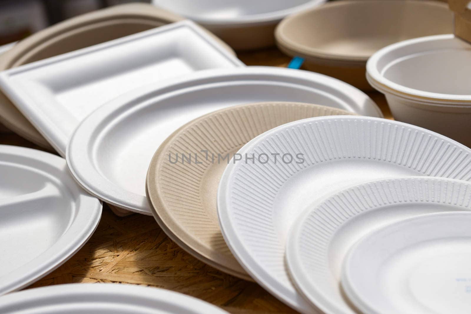 a variety of paper disposable plates of different colors