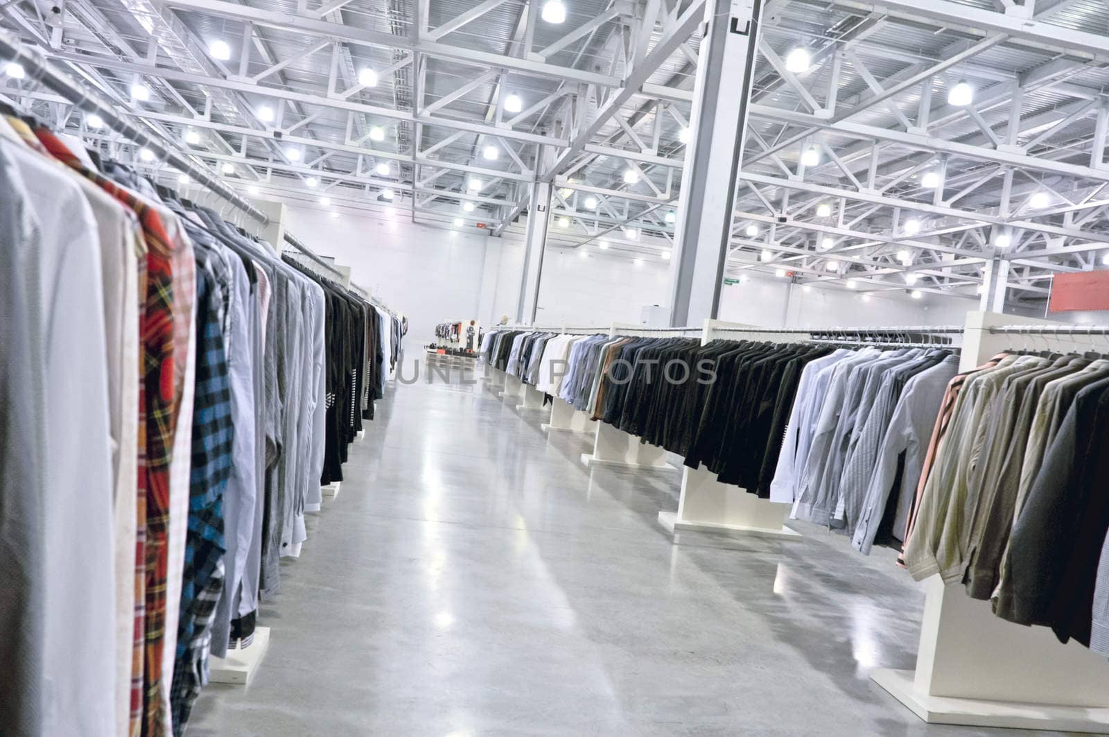 a lot of shirts on hangers in shop