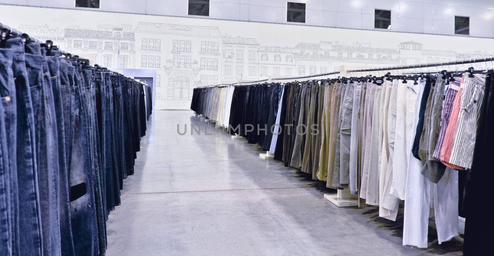 a lot of pants on hangers in shop by vlaru