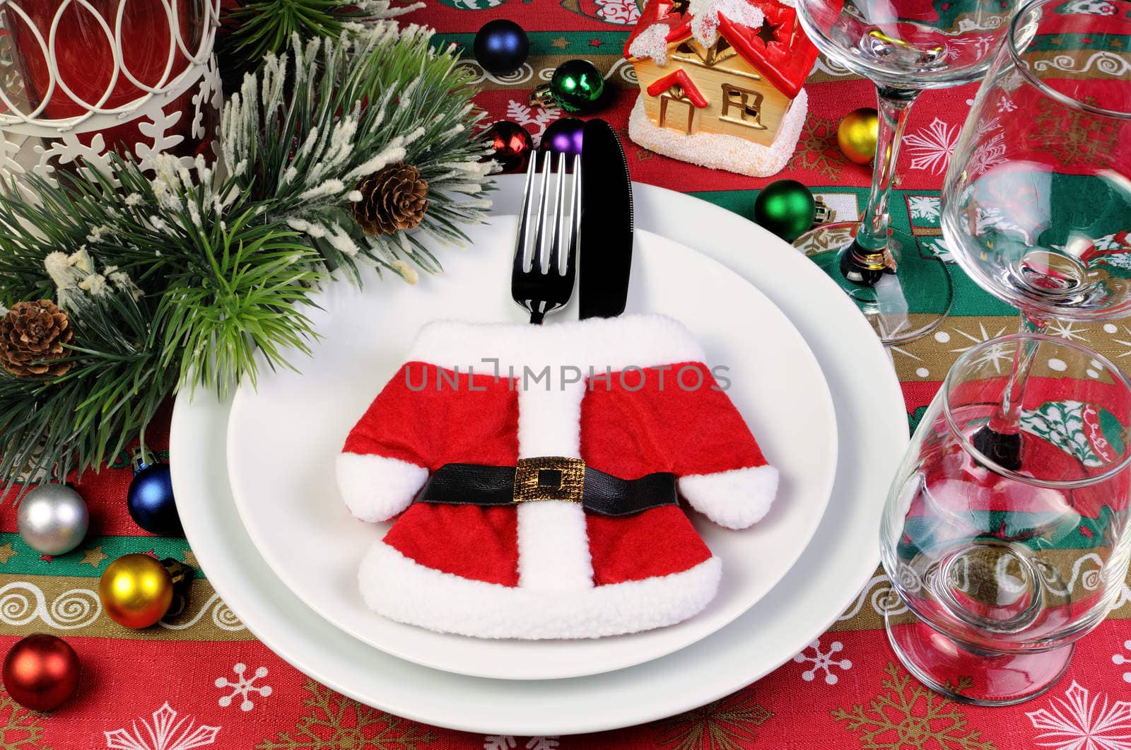 Fragment of the Christmas table serving coat of Santa Claus with cutlery