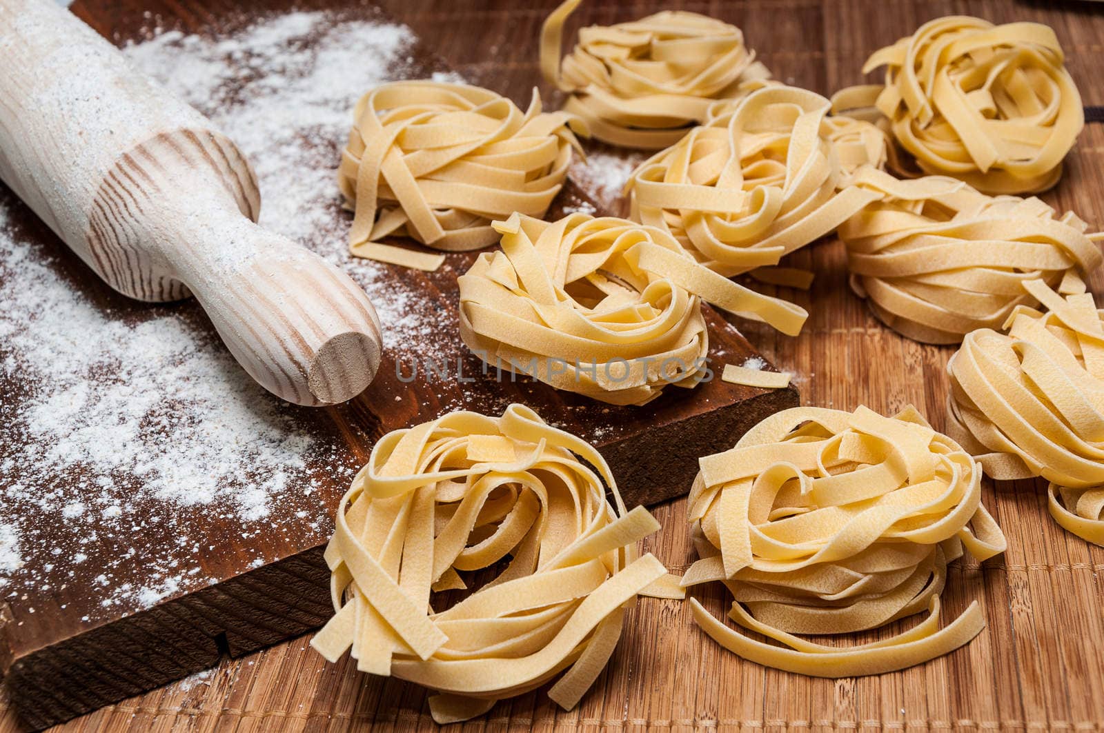 Homemade tagliatelle, flour and rolling pin