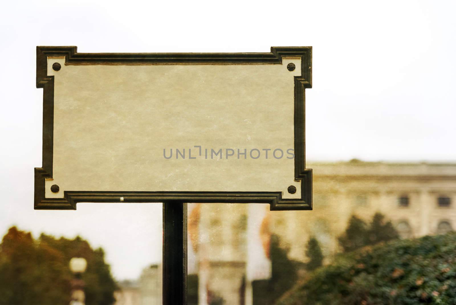 Old blank sign a blur background of the city by Zhukow