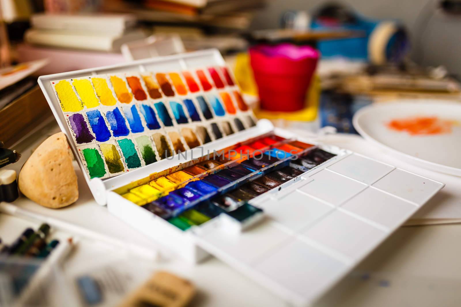 Box  of watercolors on working artist table