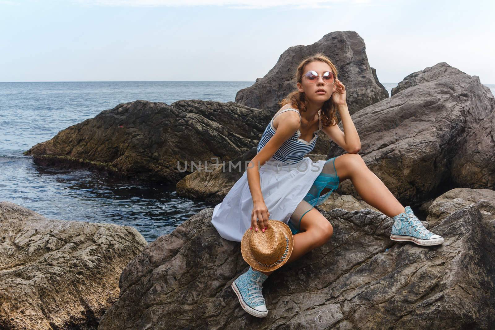 Young teen posing on stones at sea fashion photoshoot by mrakor