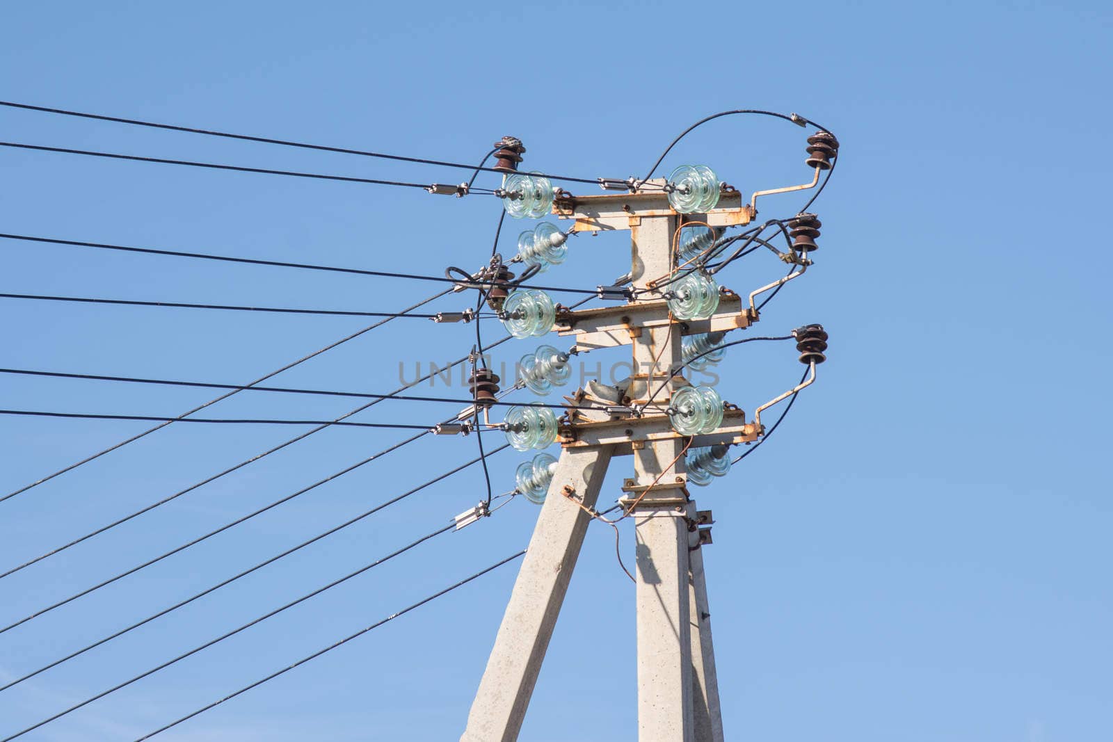 A pillar of power line installed on it, and isolated wires to prop up the pole