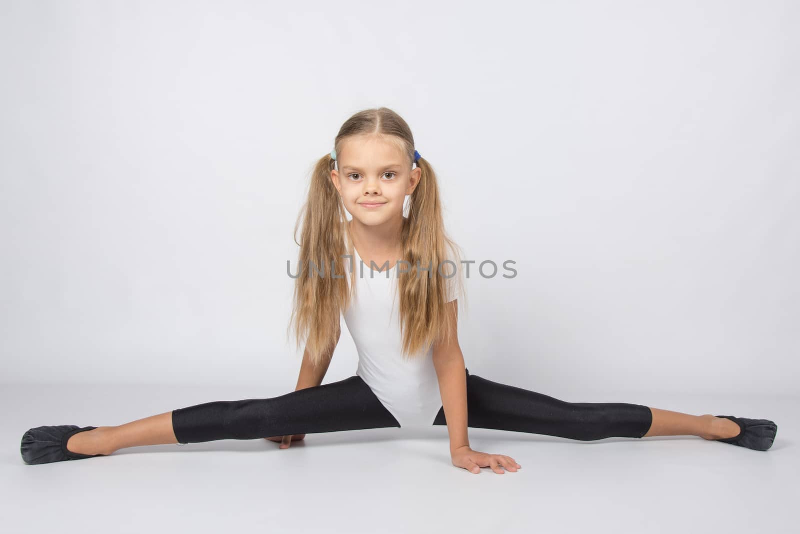six year old girl aspiring gymnast performs a number of training exercises